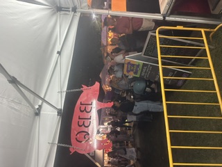 Island Que Smokers booth at a busy event
